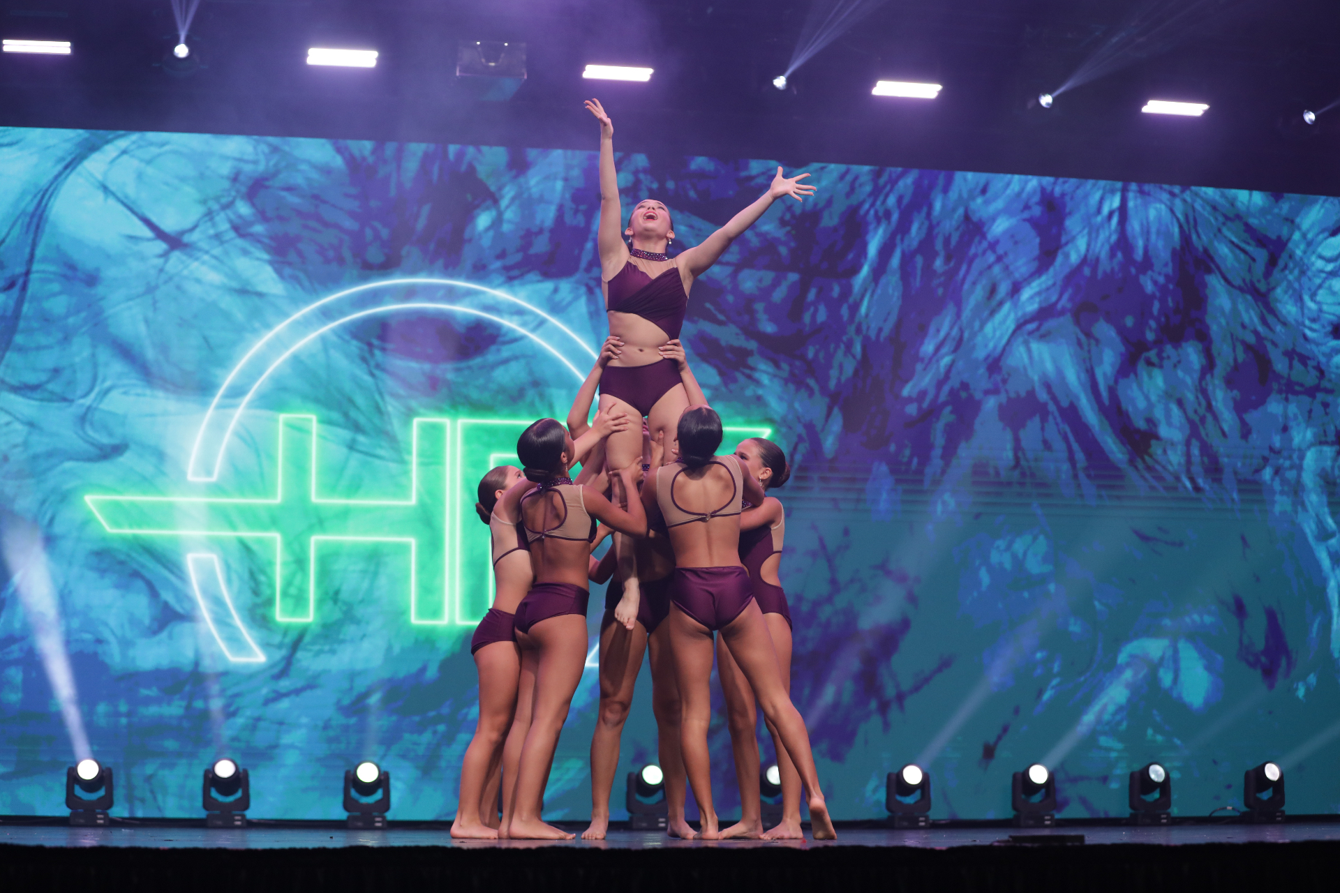 Team Pulse lift on stage