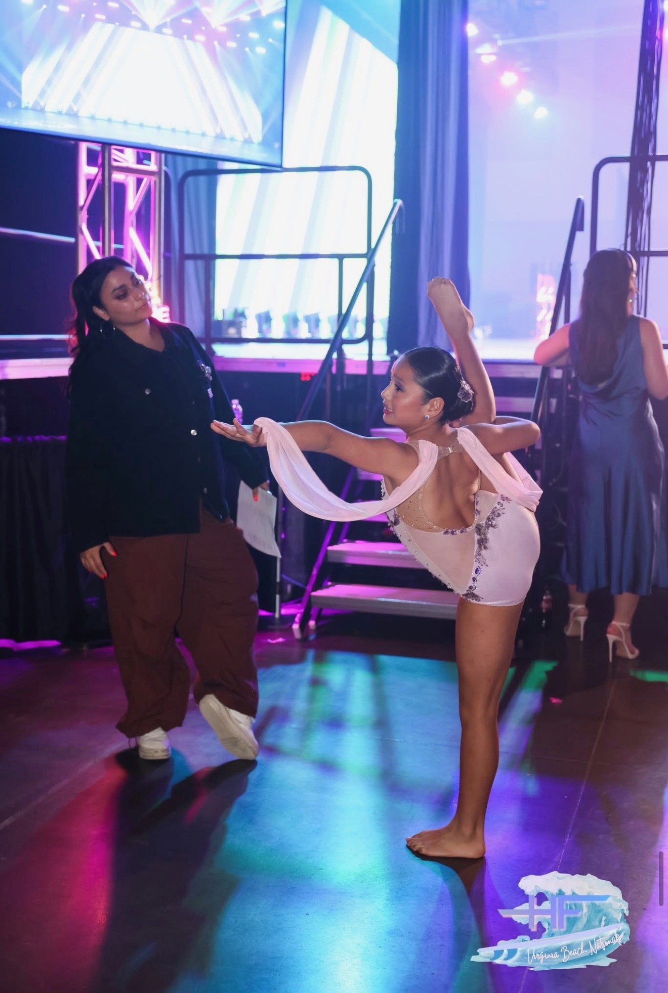 Dancer rehearsing with instructor backstage